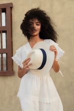 Load image into Gallery viewer, Natural Panama Extra-fine hat with navy blue band — lifestyle view